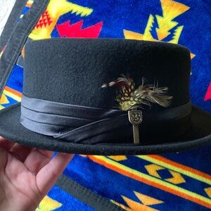 Brand new Brixton hat black with feather and emblem on the side